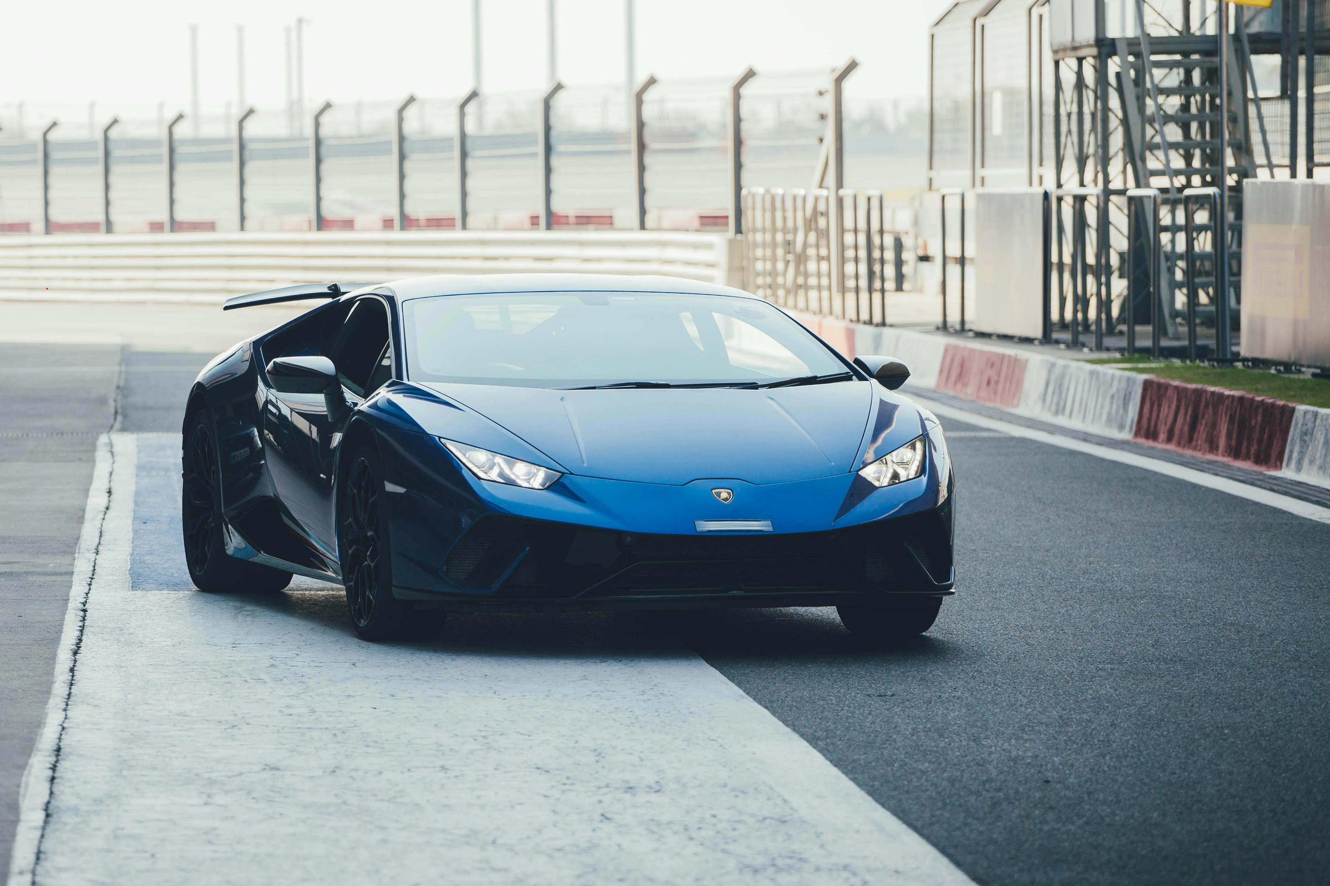 A blue Lamborghini Huracán on a racetrack